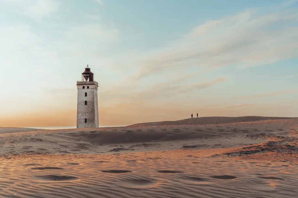 Minimalistic photo of people at sunset Rubjerg Knude Lighthouse Denmark